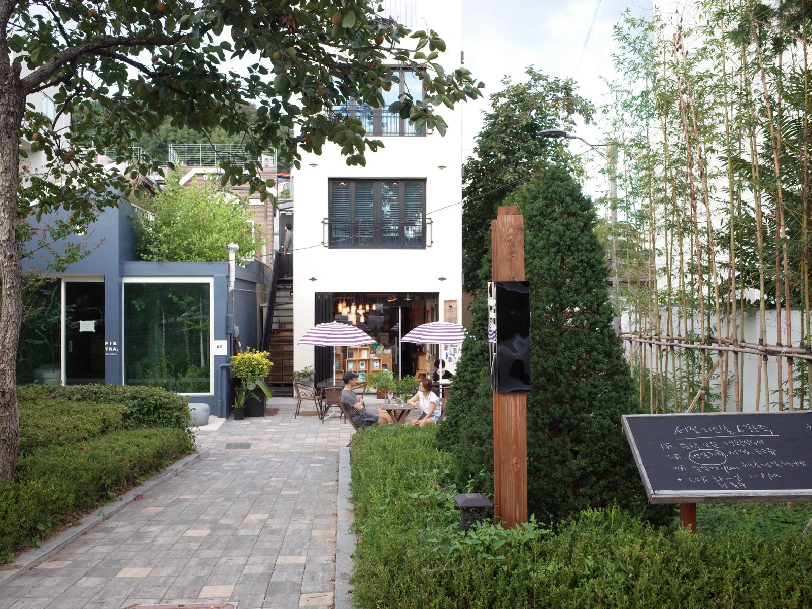 Leafy courtyard entrance leading to Bookshop Lisbon in Yeonnam-dong