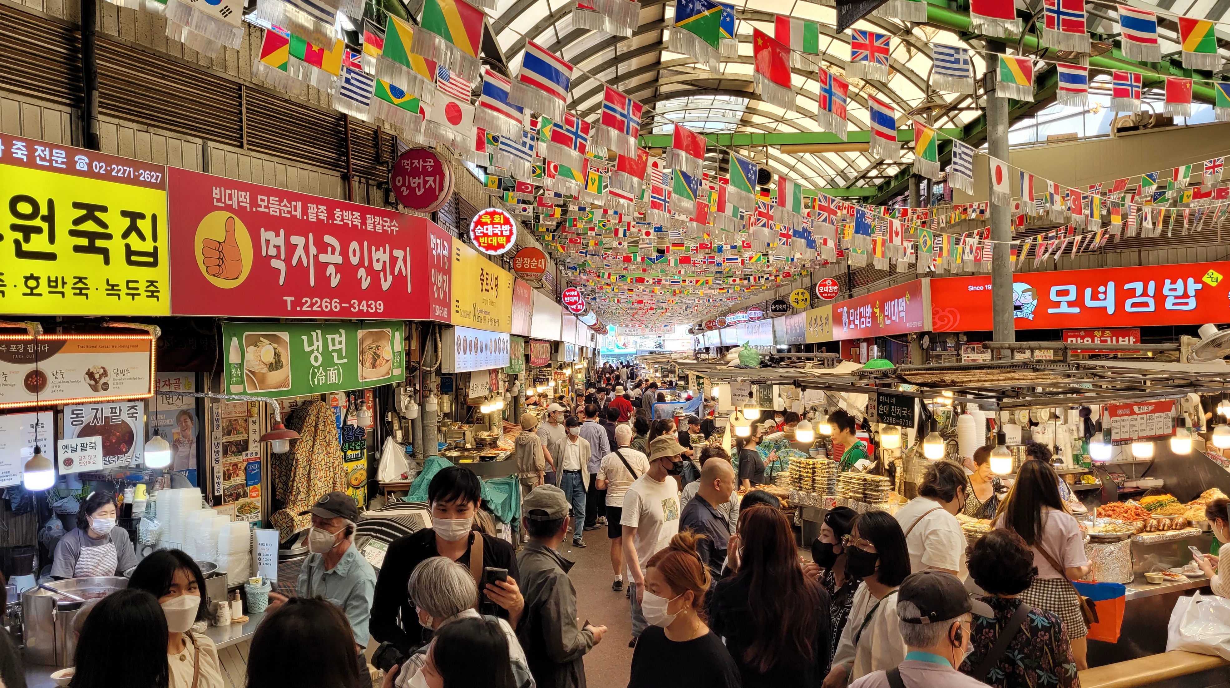 Busy food aisle inside Gwangjang Market in Seoul