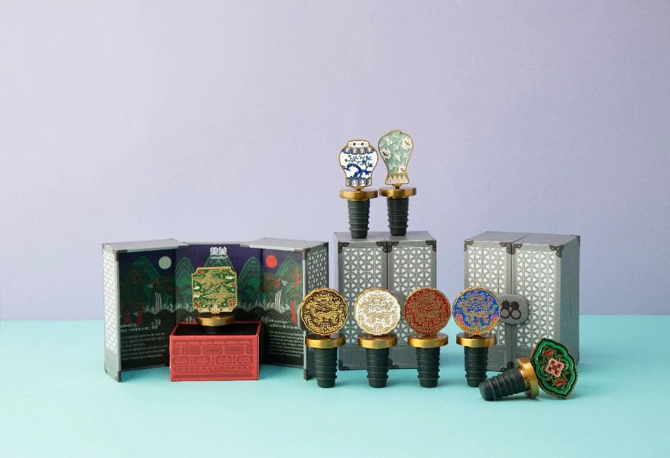 Joseon-inspired character wine stoppers displayed against a pale blue background