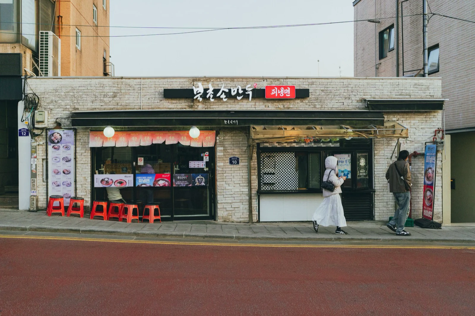 A Korean restaurant entrance in Seoul with counter windows facing the street