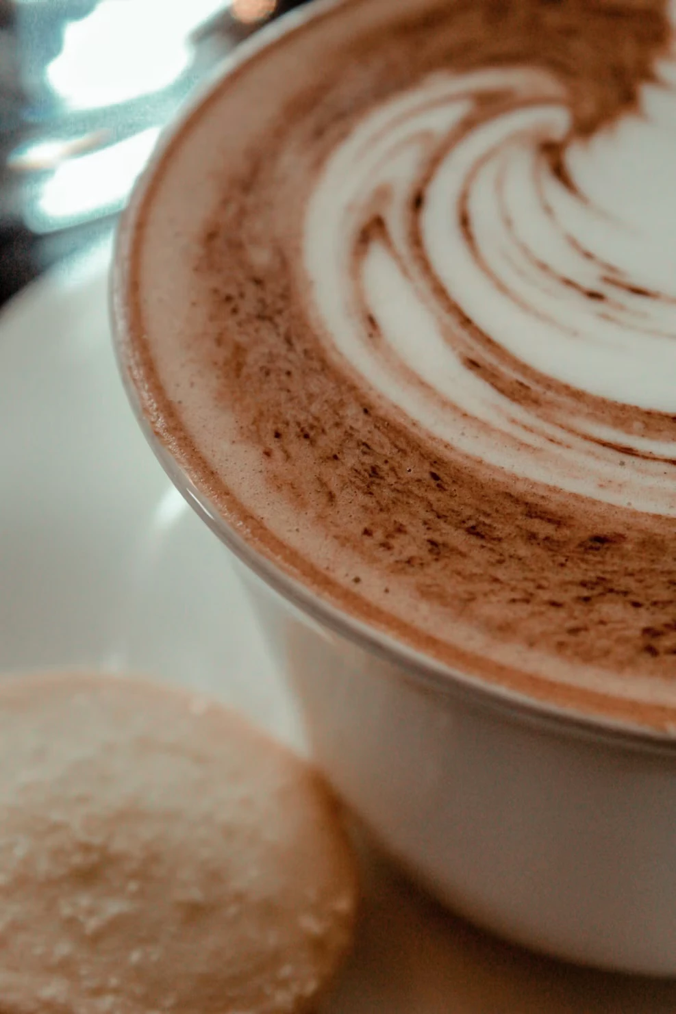 Close-up of latte art in a white ceramic cup