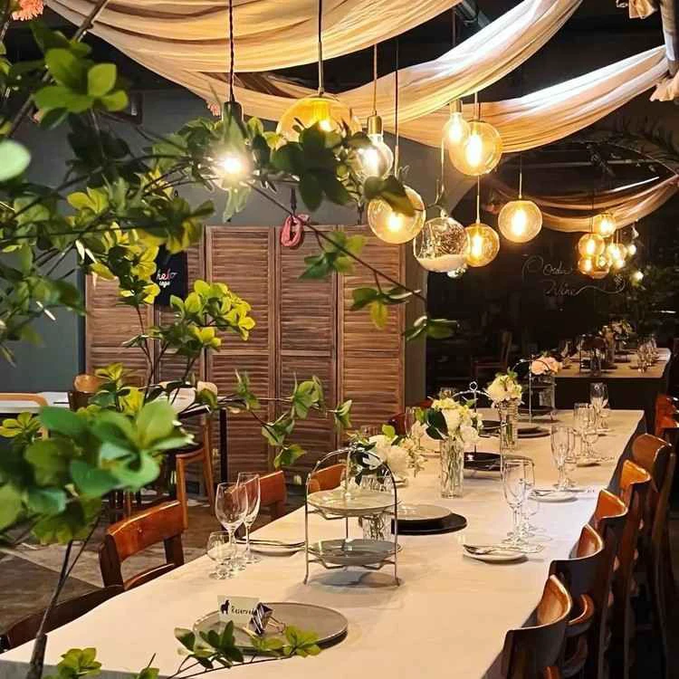 A warmly lit Korean restaurant dining room set for service