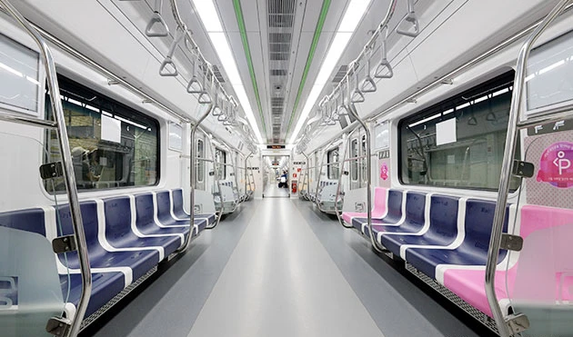 An empty Seoul subway car with rows of seats on both sides