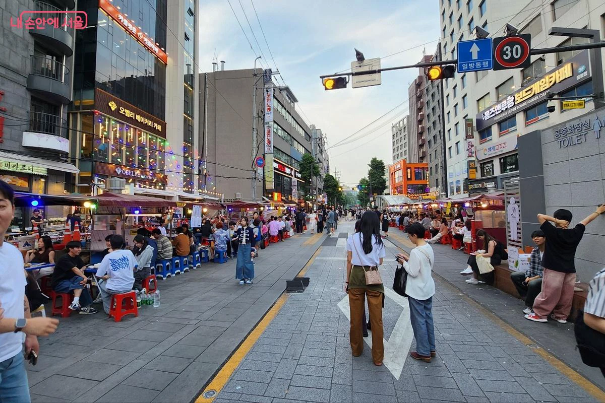 Food stalls and pedestrians along a lively street near Jongno 3-ga