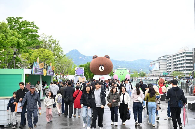 Visitors arriving at an outdoor Seoul festival area