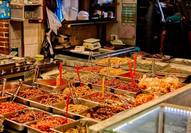 Prepared side dishes and market food displayed at Mangwon Market in Seoul