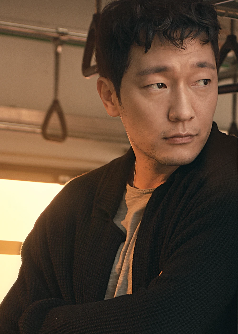 Son Suk-ku as Mr. Gu in the JTBC drama My Liberation Notes, seated alone in warm light