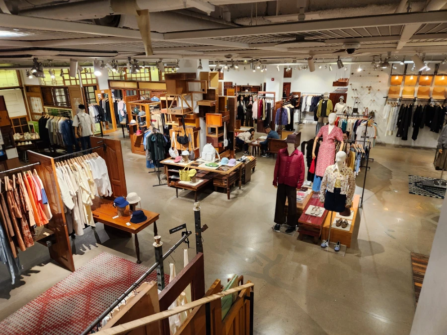 BEAKER Hannam interior viewed from above, with clothing racks and warm wooden display furniture