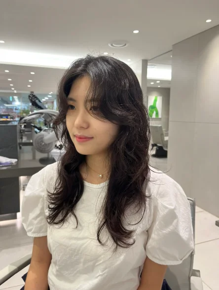 A finished long layered hairstyle with face-framing waves at Juno Hair Seoul Station