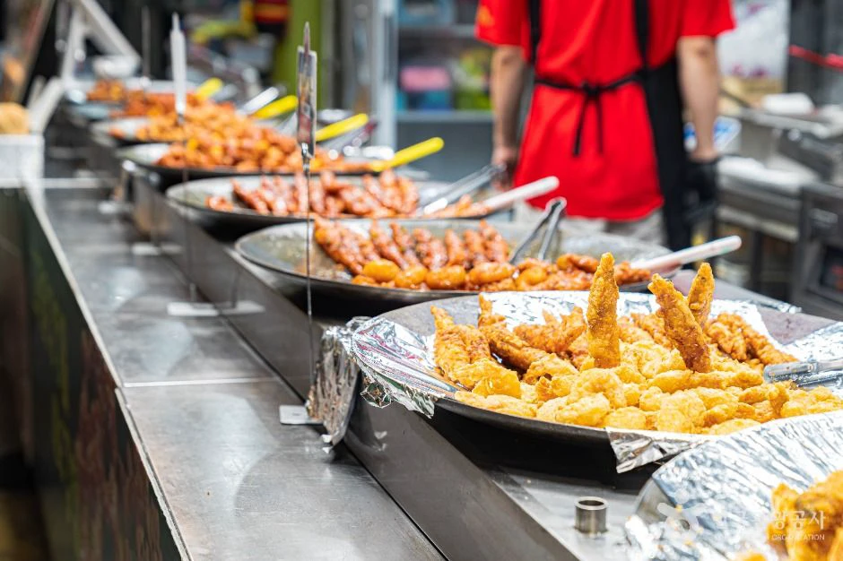 Freshly fried snacks displayed at a counter inside Mangwon Market