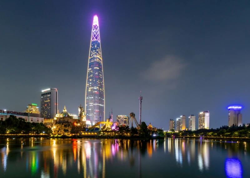Magic Island and Lotte World Tower reflected across Seokchon Lake at night