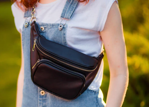 Traveler wearing a small cross-body bag that can keep prescribed emergency medicine close