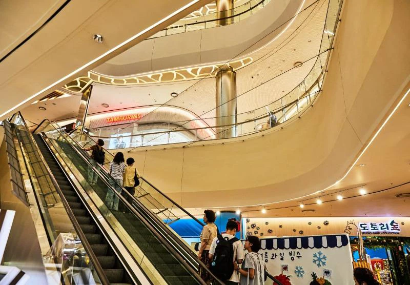 Curved indoor atrium and escalators inside Starfield COEX Mall