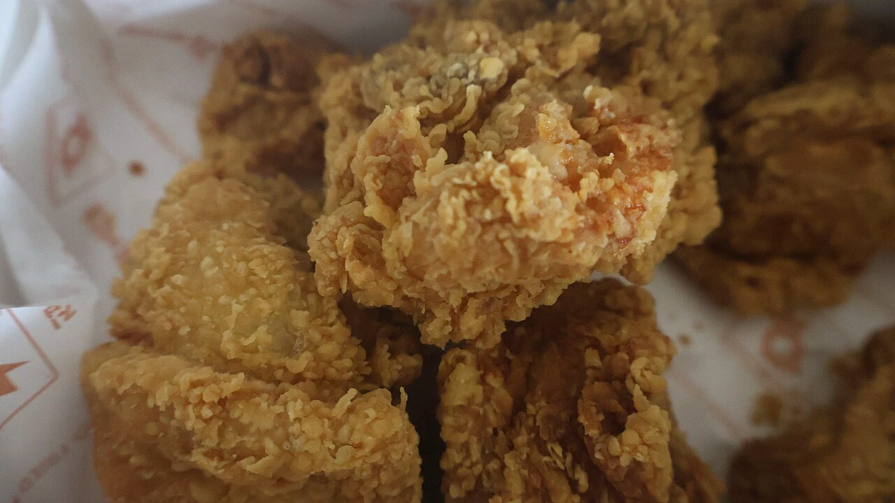 Crispy Korean fried chicken pieces in a paper-lined box