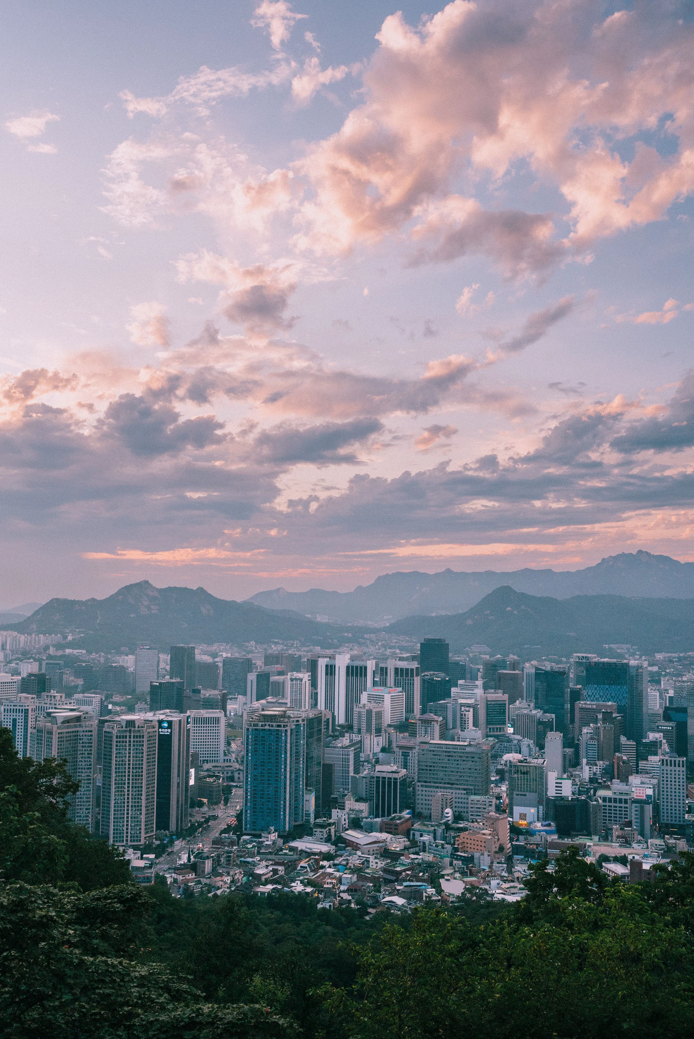 A wide view across dense Seoul housing and office districts at dusk