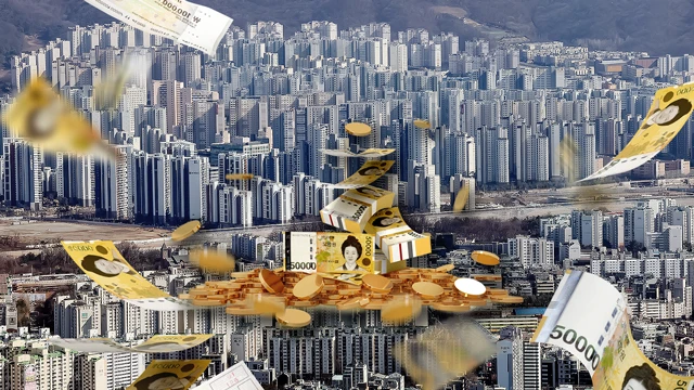 Korean won notes and coins against a dense apartment district