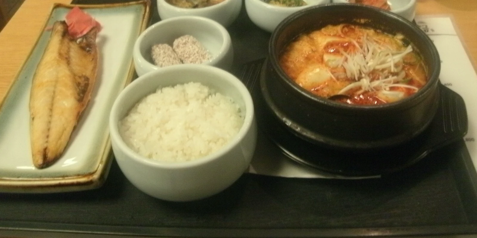 Korean breakfast set with rice, hot soup, grilled fish and small side dishes