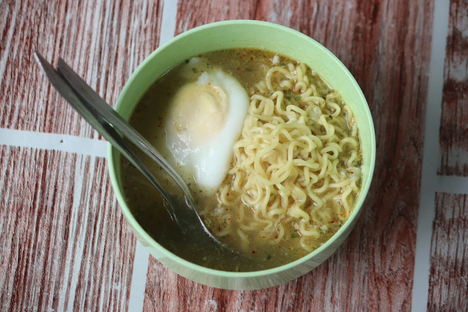 Cooked instant noodles in a bowl with a boiled egg