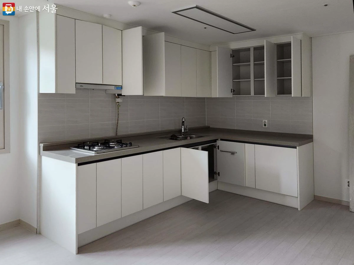 Built-in kitchen, refrigerator, and storage cabinets inside an 18-square-metre Seoul one-room