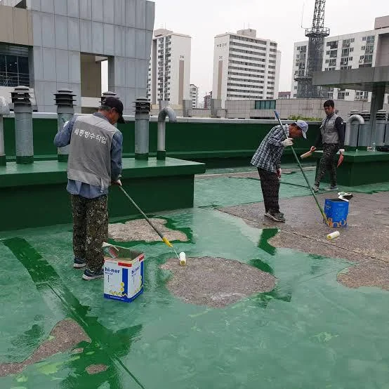 Workers rolling green waterproof coating across a flat urban rooftop in Korea