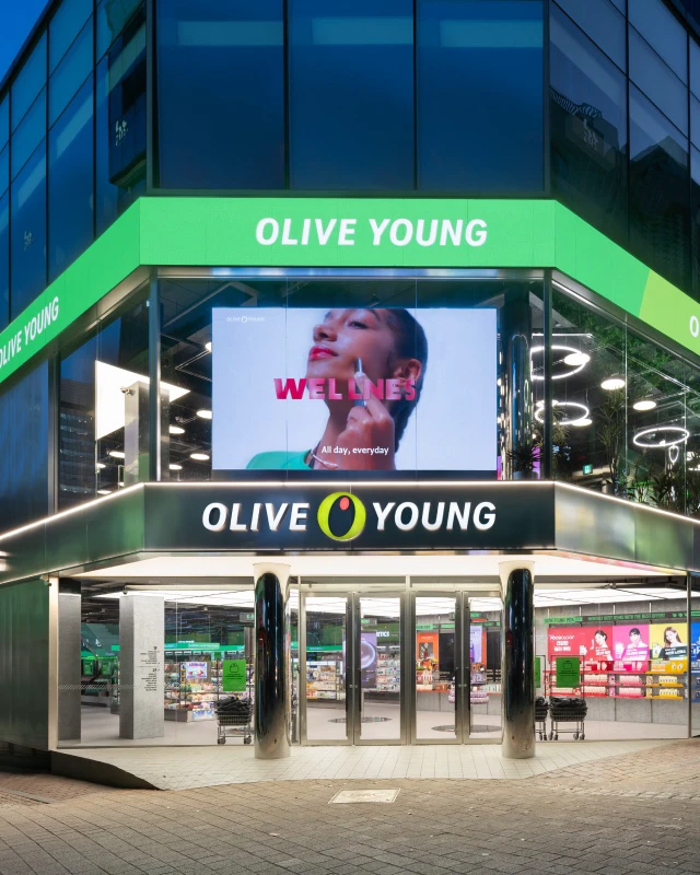 Illuminated Olive Young Myeongdong Global Town storefront at night