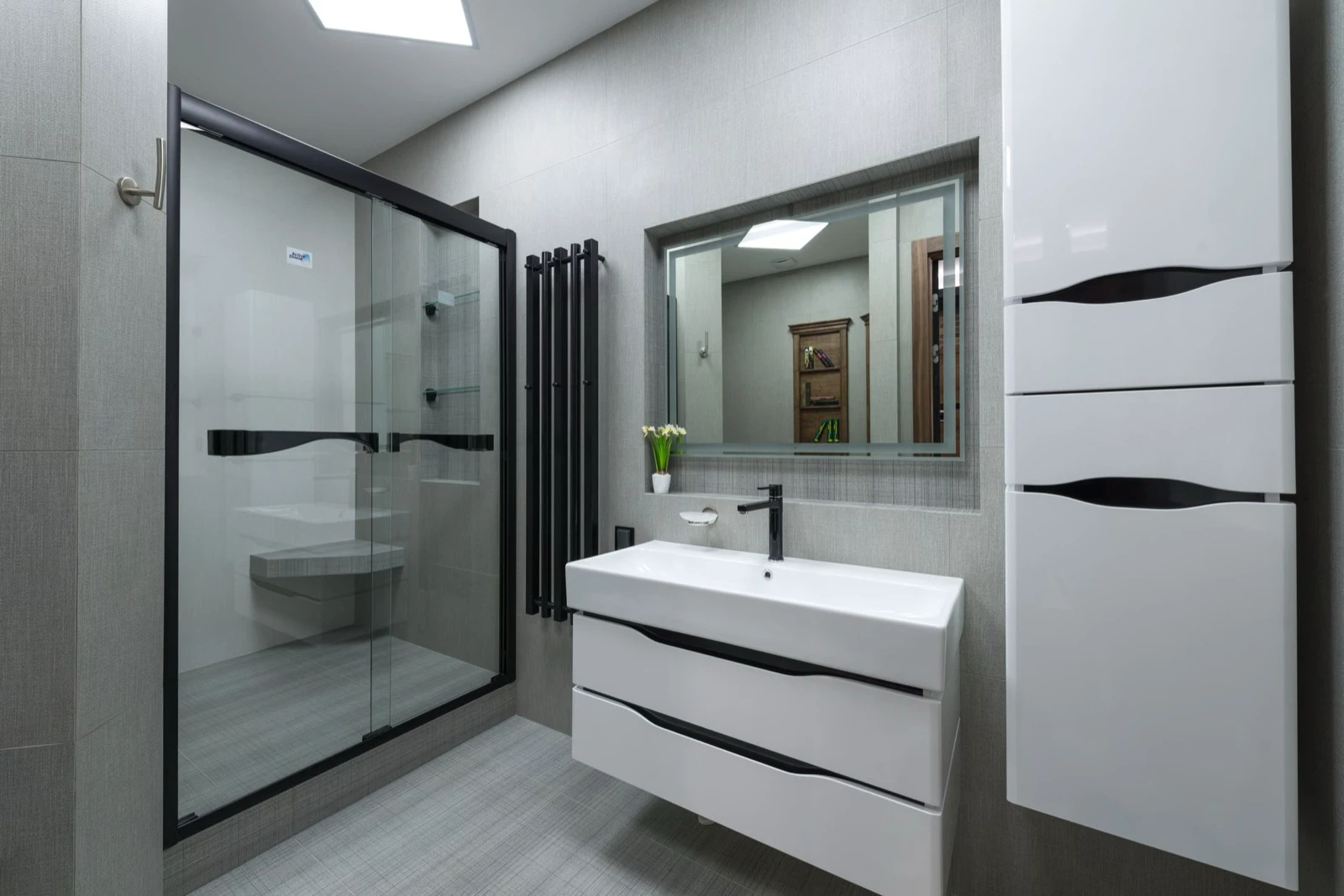 Bright modern bathroom with a glass shower cabin and no bathtub