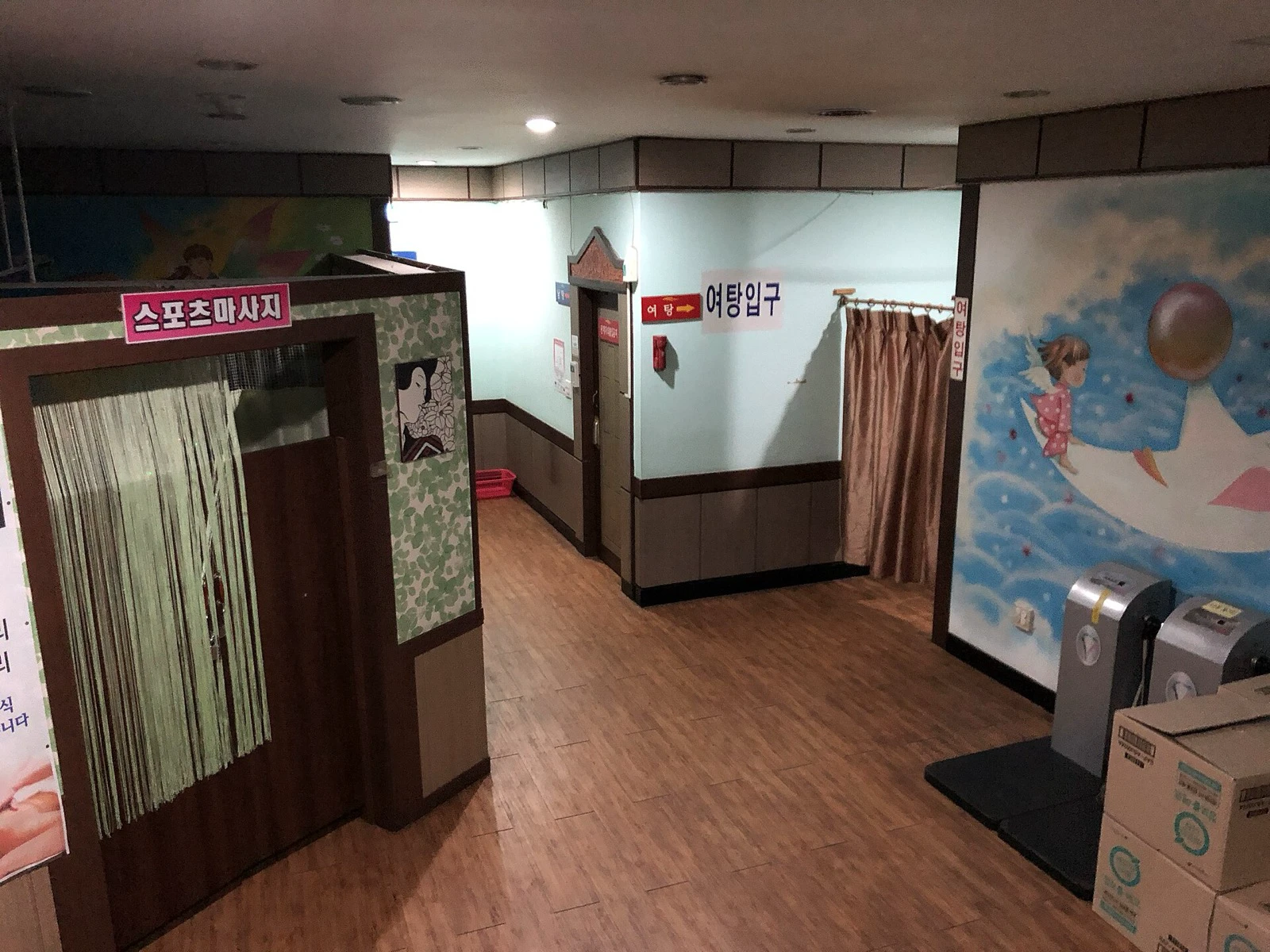 Empty corridor leading to the women’s bathing entrance inside a Korean jjimjilbang