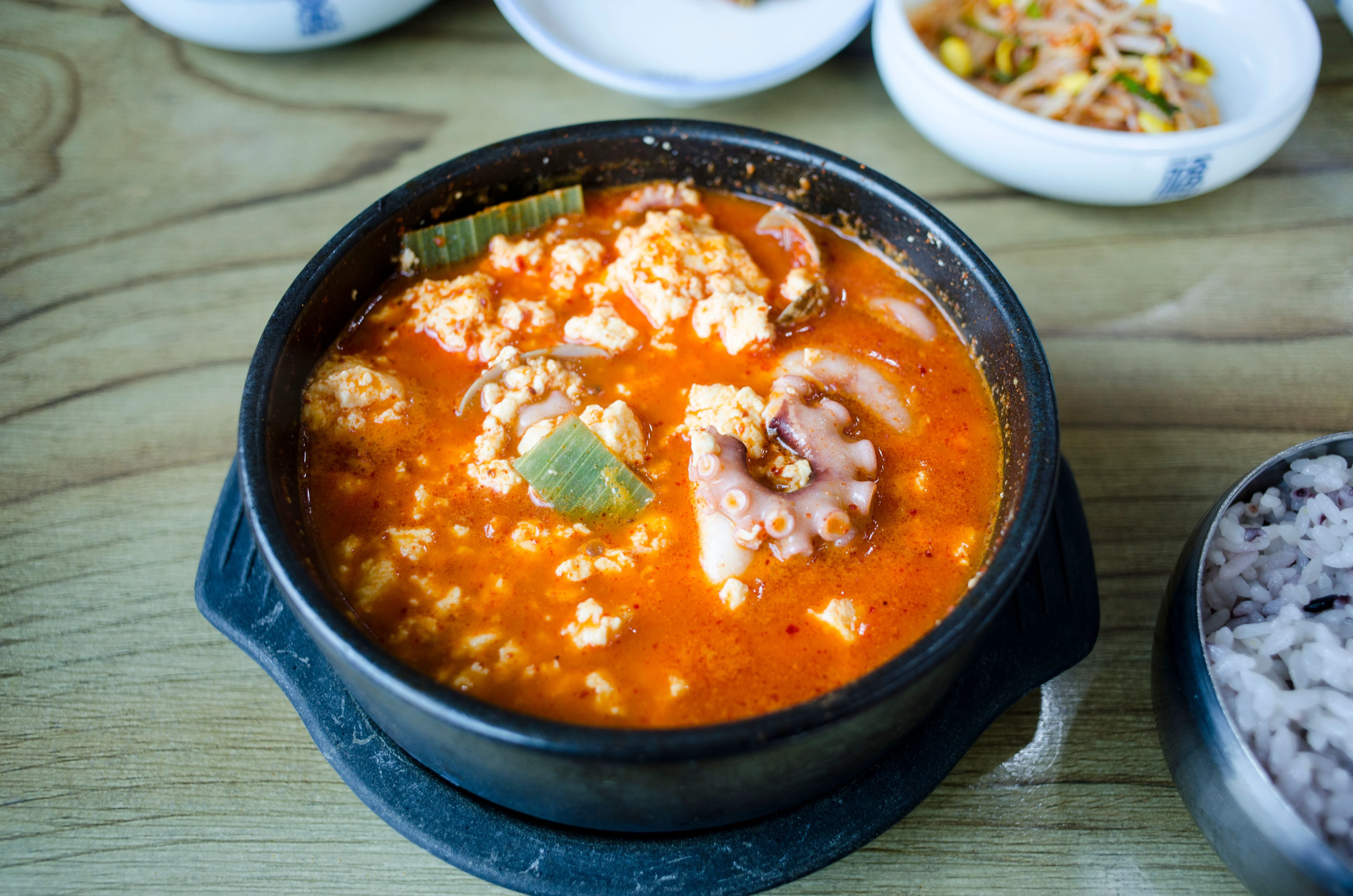 Seafood sundubu jjigae with soft tofu curds and octopus in a bubbling red broth
