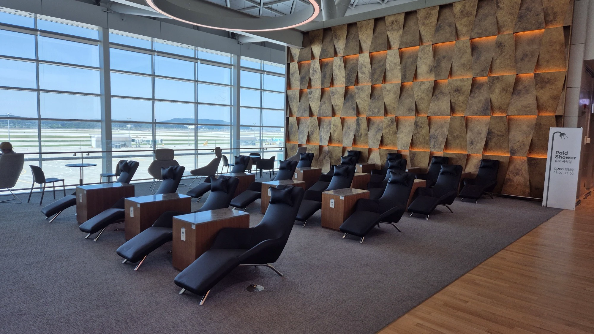 Rows of reclining chairs in the official public lounge near Gate 231 at Incheon Airport Terminal 2