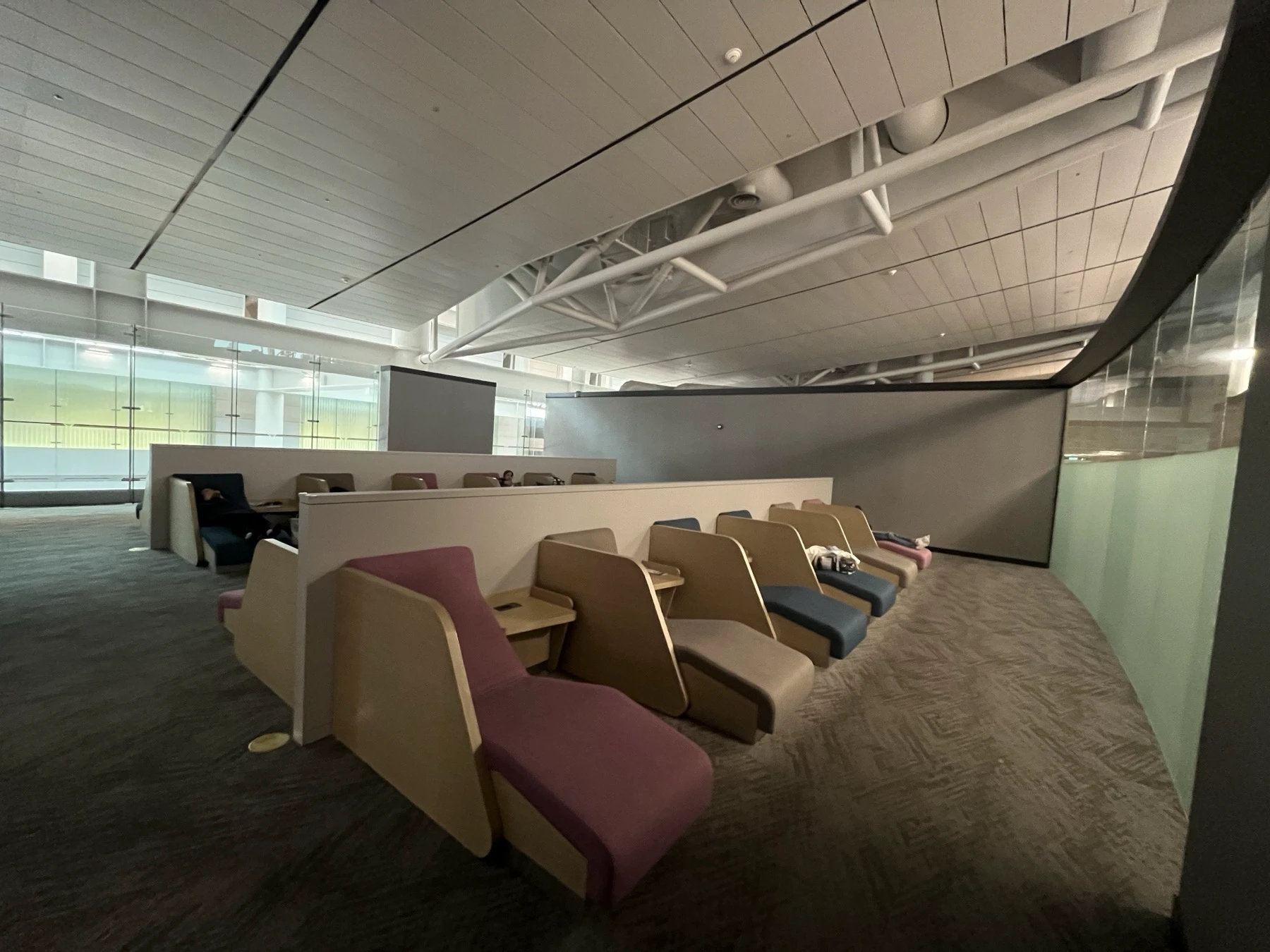 Semi-private reclining seats separated by low partitions in the Terminal 1 East nap zone