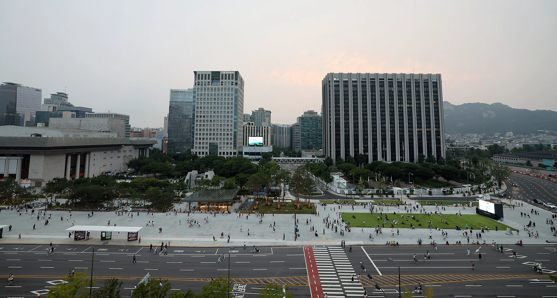 Wide evening view across Gwanghwamun Square and central Seoul