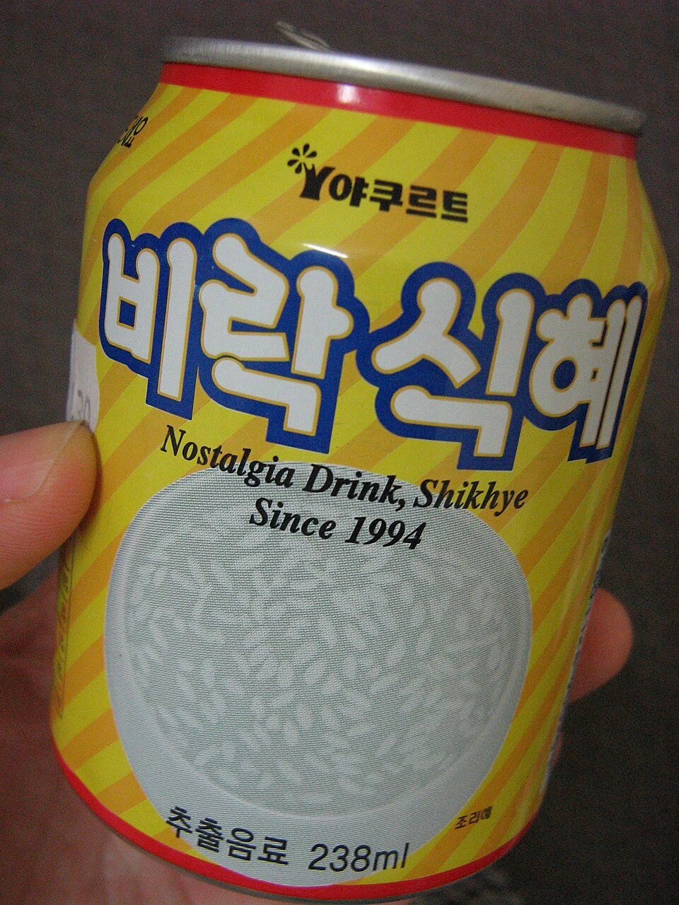 Can of Korean sikhye sweet rice drink held in one hand
