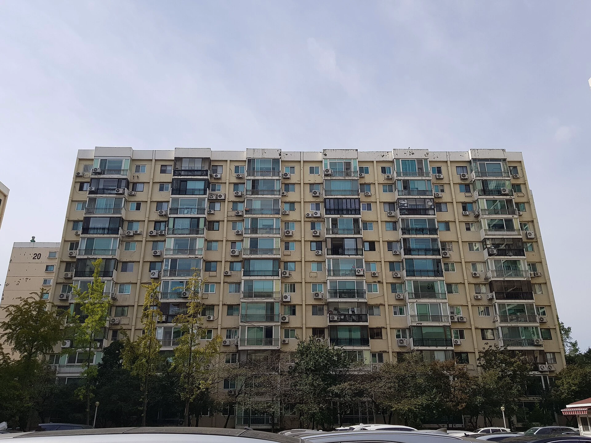 Weathered 1976 Hyundai apartment building in Apgujeong with enclosed balconies and outdoor air conditioners
