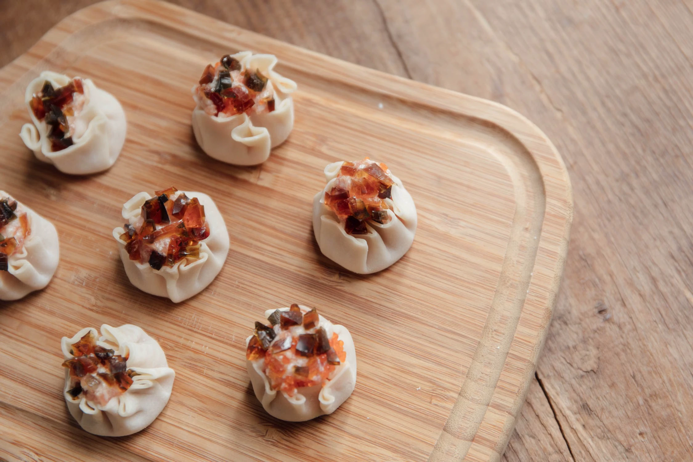 Steamed open-topped dumplings on a wooden tray as a mild dinner protein reference