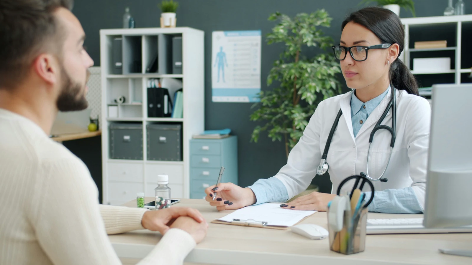 Clinician listening to a patient during a private consultation before treatment