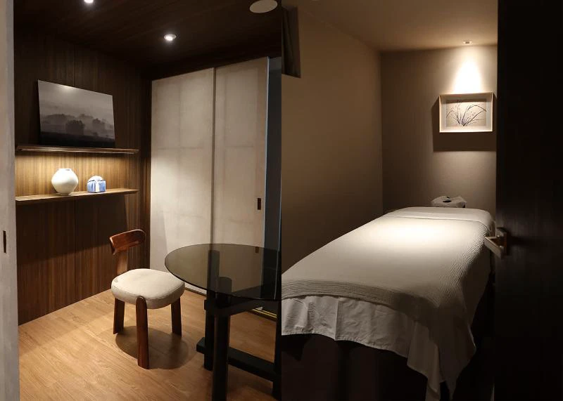Private spa treatment room in Seoul with a prepared treatment bed and consultation table