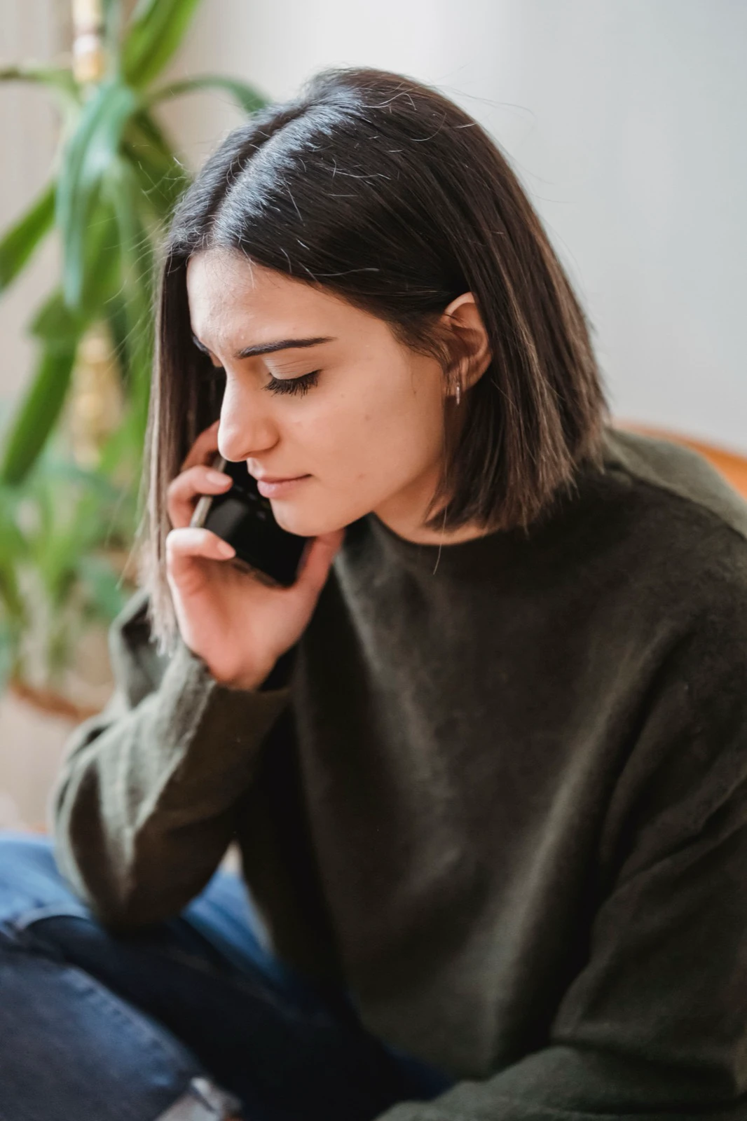 A renter making a phone call while seated at home