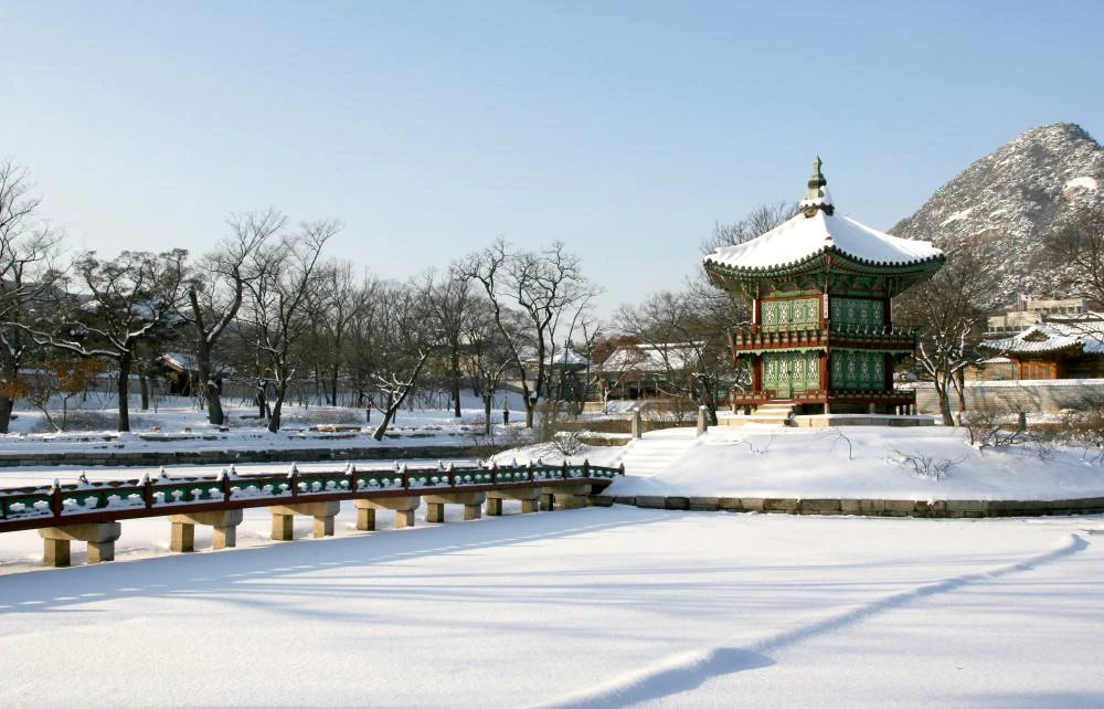 Hyangwonjeong Pavilion and its bridge surrounded by fresh snow at Gyeongbokgung Palace