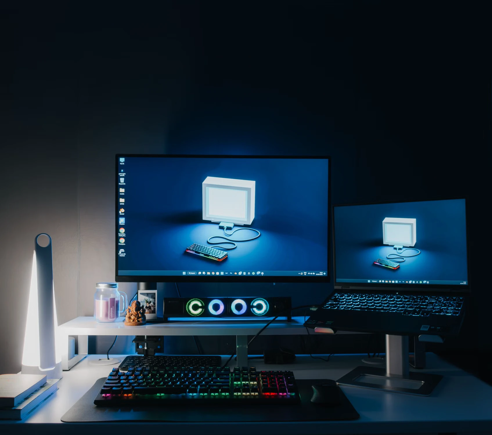 Dual-monitor gaming desk with an illuminated keyboard and mouse