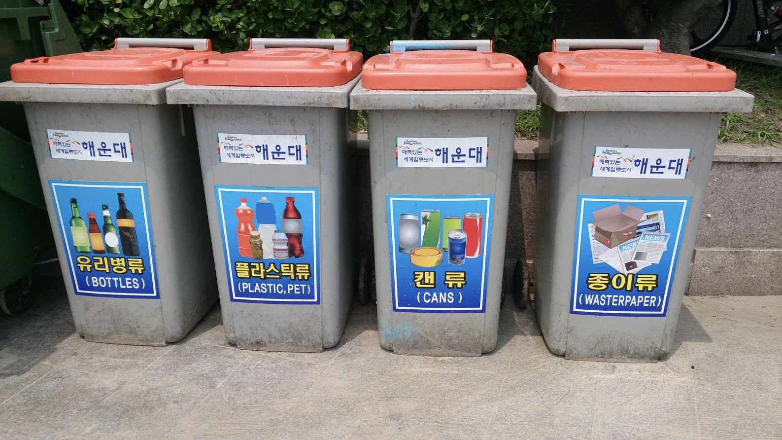 Four recycling bins in Korea labeled for bottles, plastic, cans and waste paper
