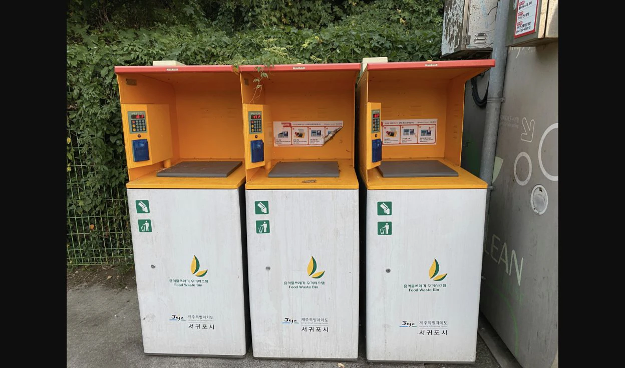 Three card-operated food-waste weighing bins with Korean instructions