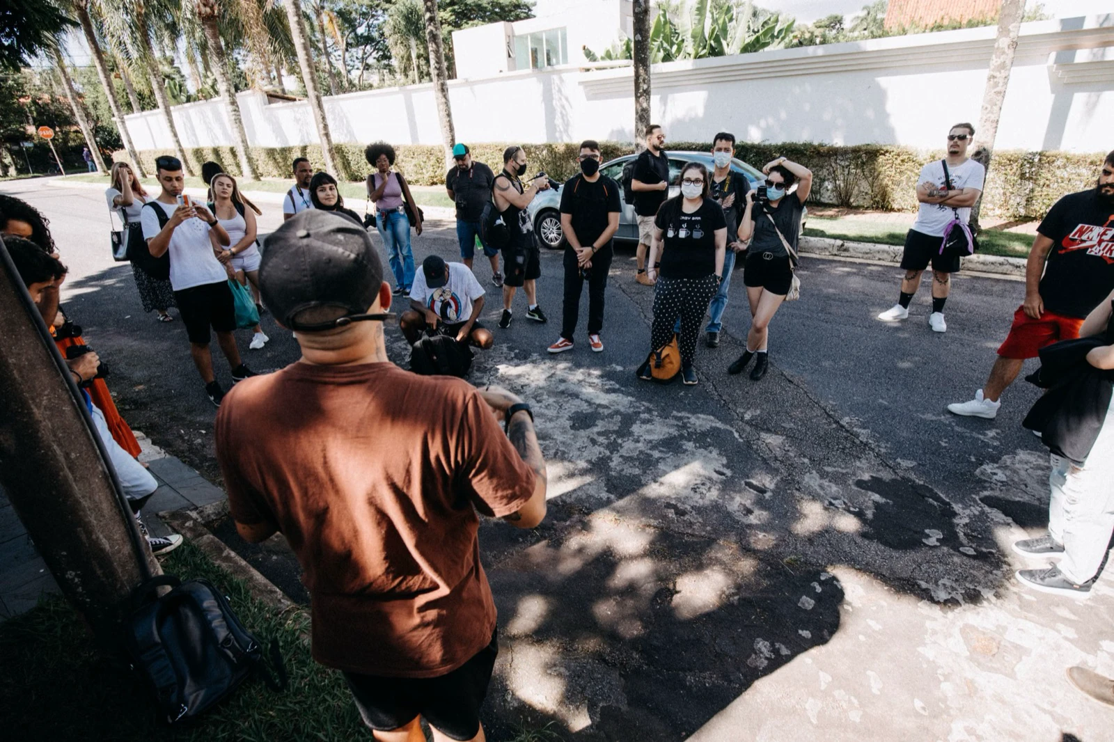 A guide addressing a group gathered outdoors on a city street