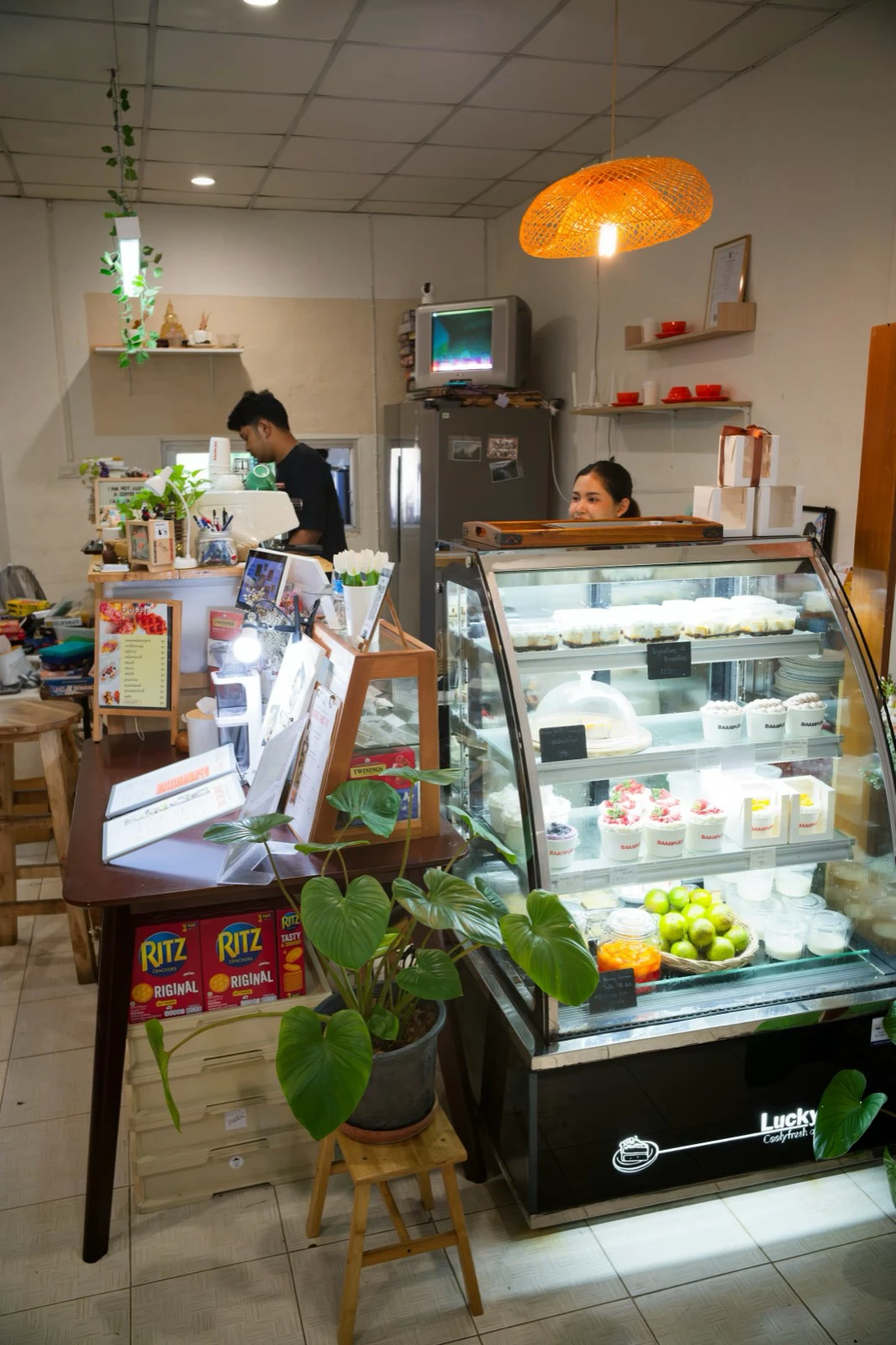 A cafe dessert case showing the cakes and chilled items available at the counter