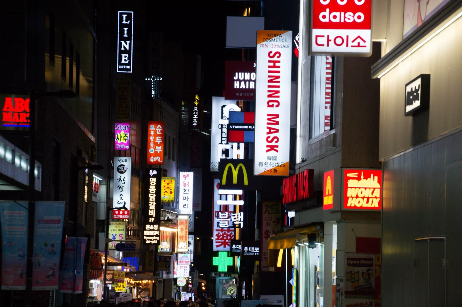 Papan warna-warni toko dan restoran menerangi kawasan komersial Seoul pada malam hari