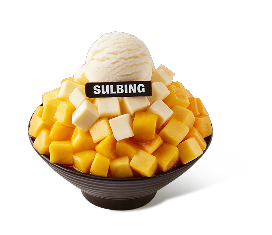 A full-size Sulbing apple mango cheese bingsu piled with mango, cheesecake cubes, and ice cream