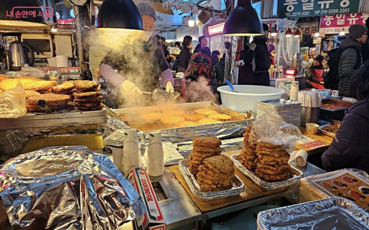 Bindaetteok frying at a Gwangjang Market food counter