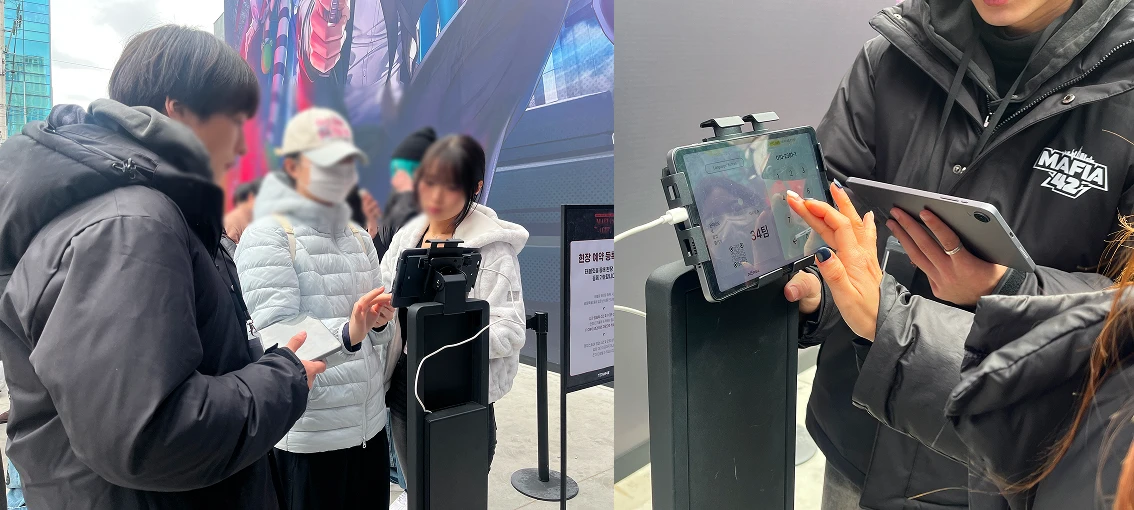Visitors registering at tablet kiosks for a digital pop-up waiting list