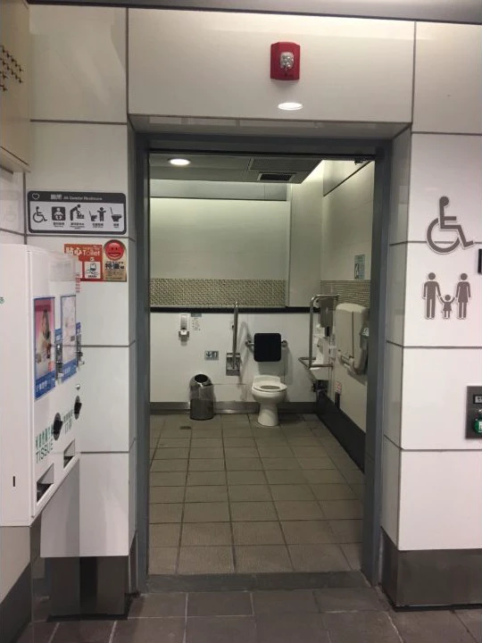 All-gender accessible restroom at Taipei Arena Station with family and wheelchair symbols