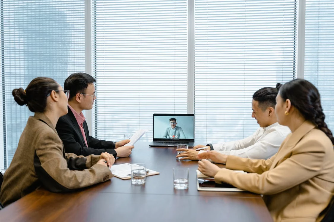 Colleagues in Seoul meeting with a remote teammate